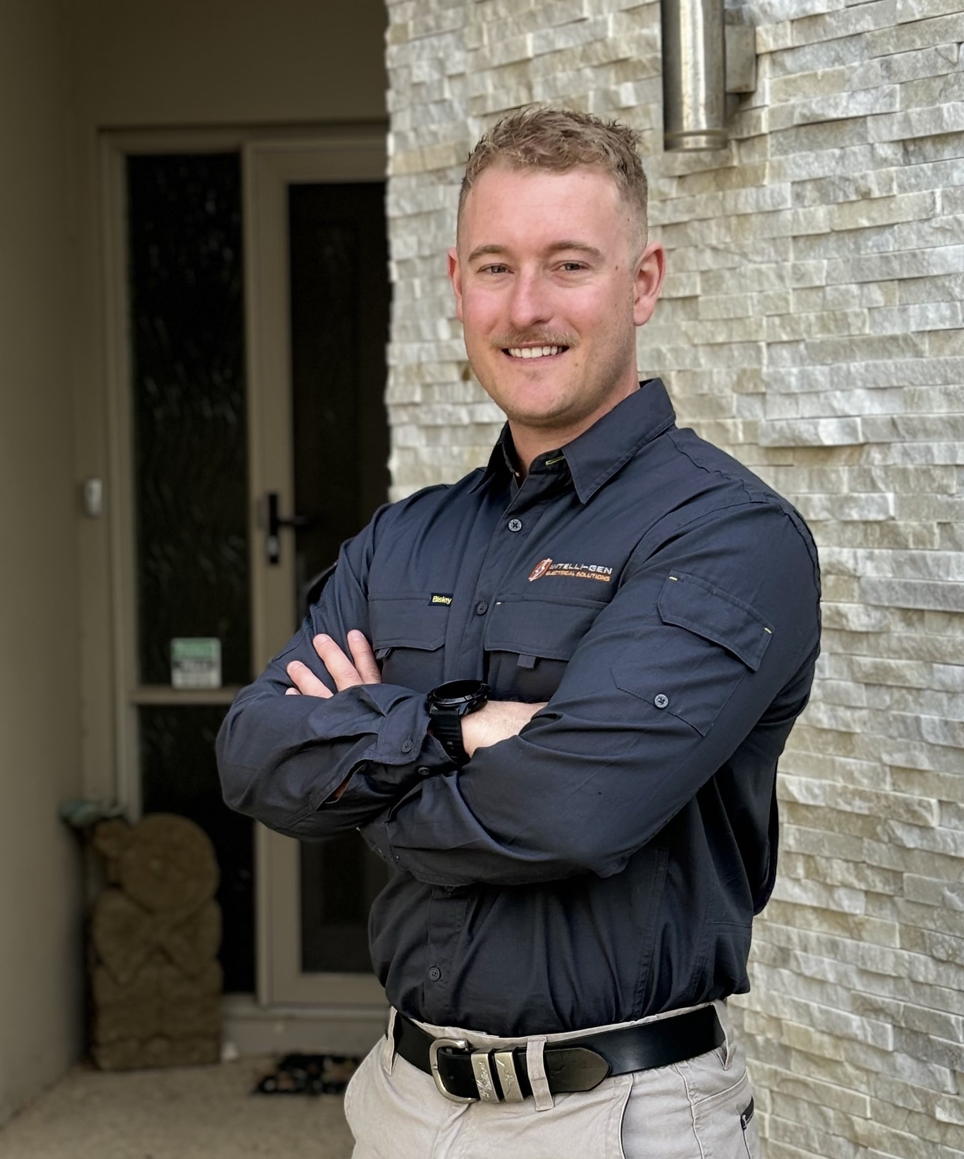 image of the owner of intelli-gen electrical standing outside of a perth home