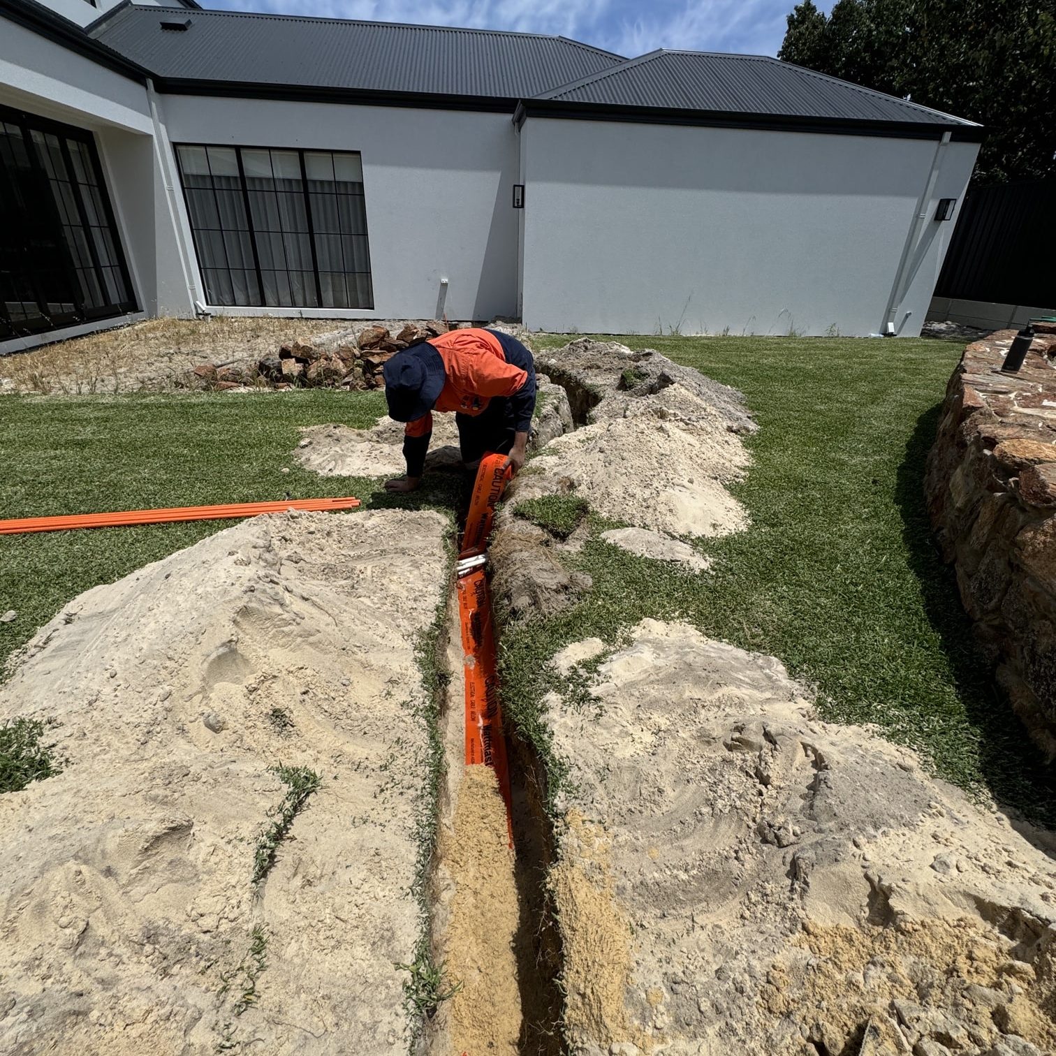 electrician digging trench for underground power